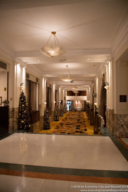 a hallway with christmas trees and lights