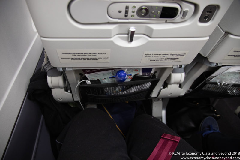 a person's legs in an airplane
