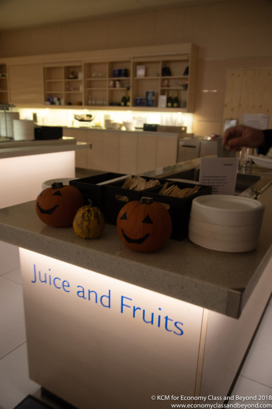 a counter with pumpkins and utensils on it