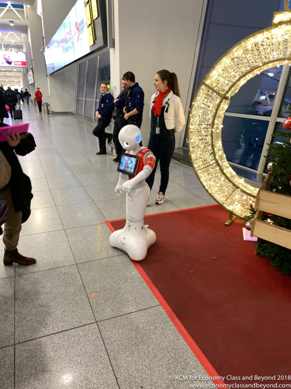 a robot standing on a red carpet