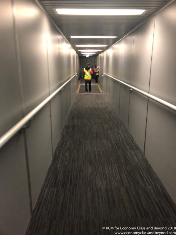 a man in a yellow vest standing in a hallway