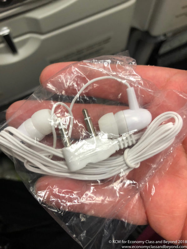 a hand holding a white earbuds