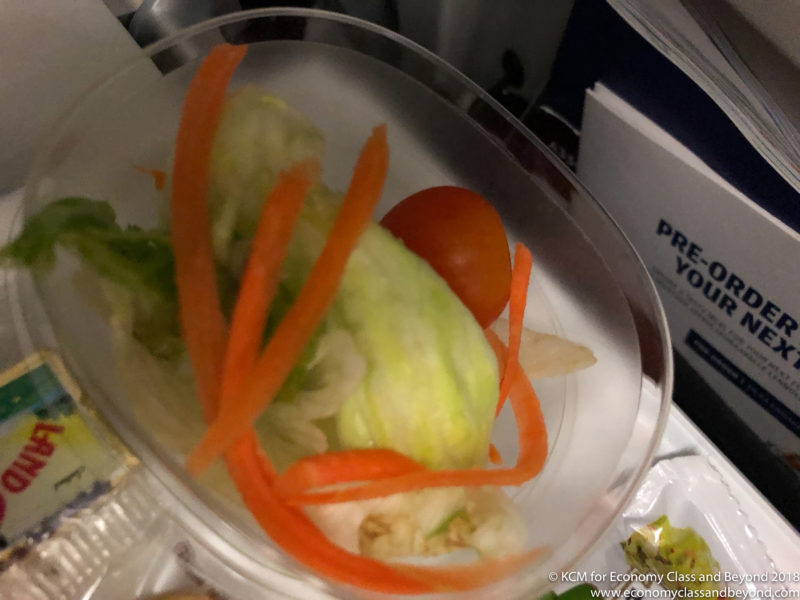 a bowl of salad with carrots and lettuce