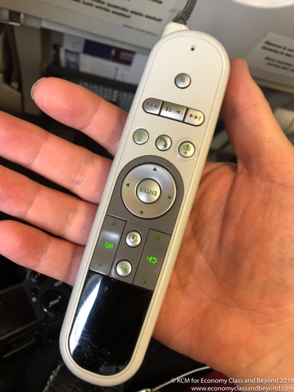 a hand holding a remote control