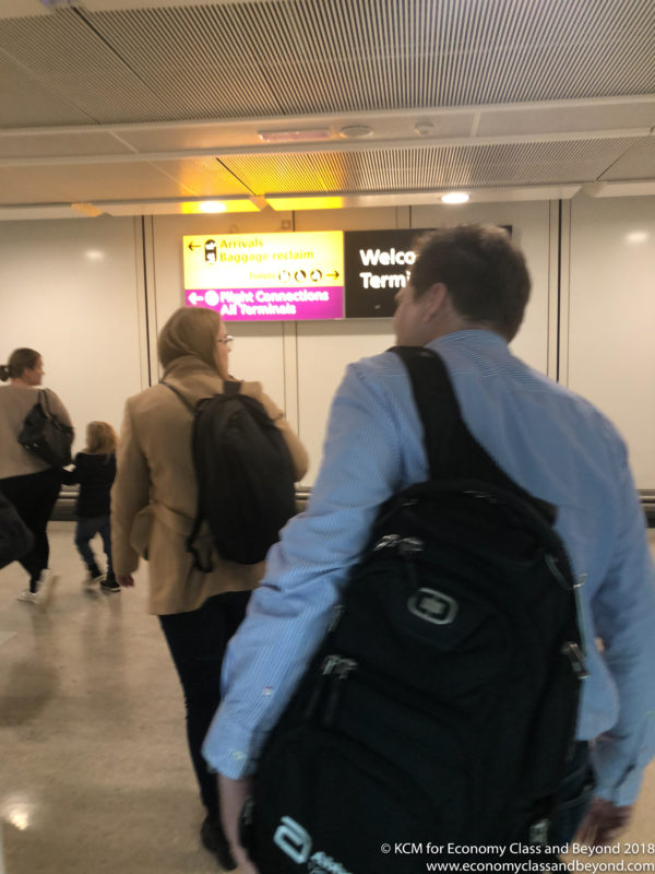 a man and woman walking in an airport