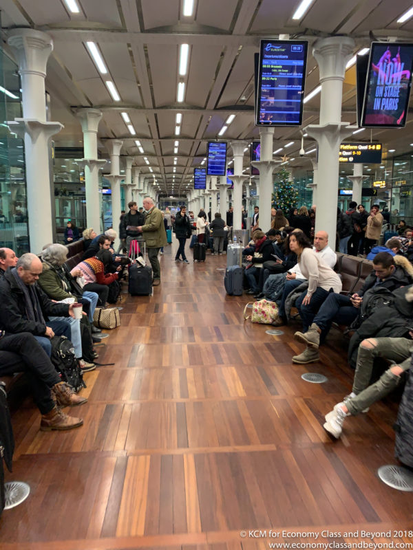 a group of people sitting on benches in a terminal
