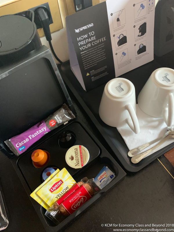 a tray with coffee cups and other items on a table