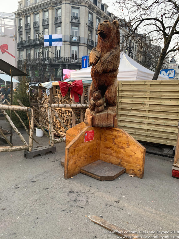 a wooden sculpture of a bear and a bear
