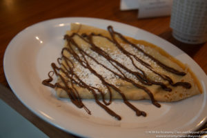 a crepe with chocolate drizzle on it