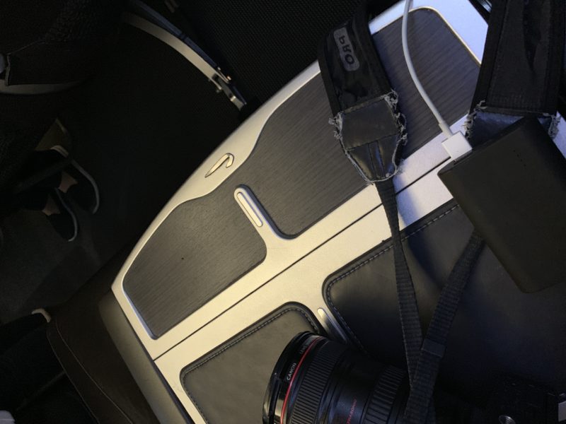 a camera and a camera strap on a seat