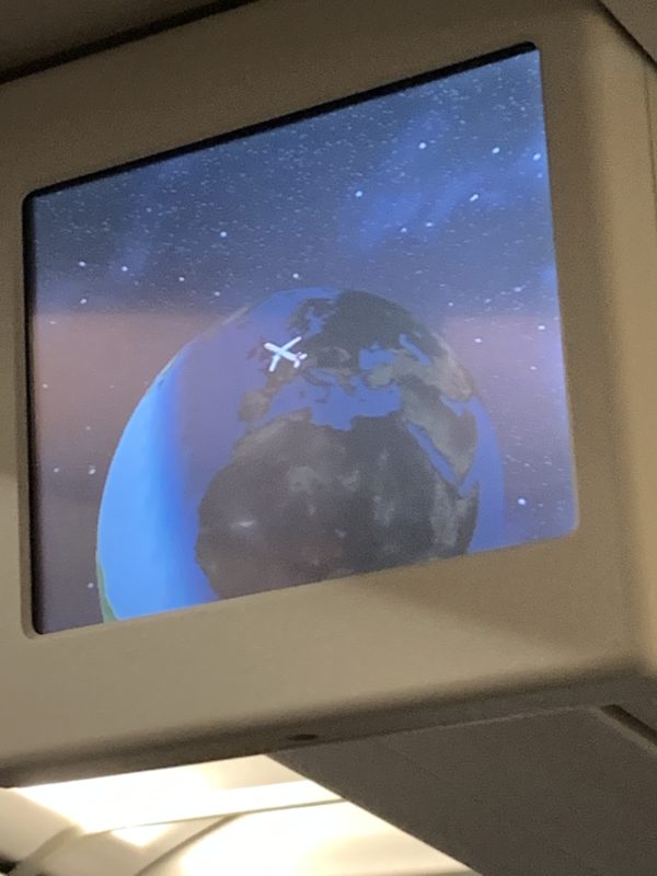 a screen with a picture of the earth and a plane