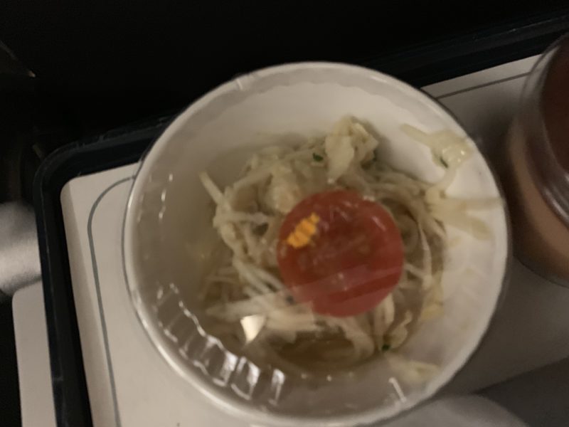 a small plastic cup with a tomato in it