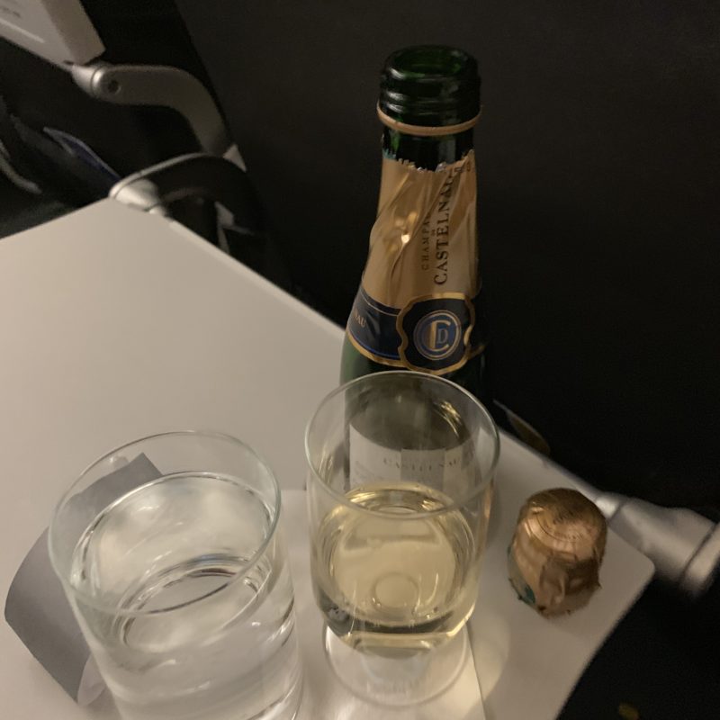 a bottle of champagne and two glasses of water