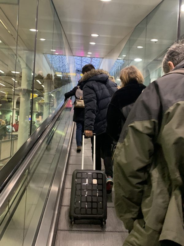 people on an escalator with a person on it