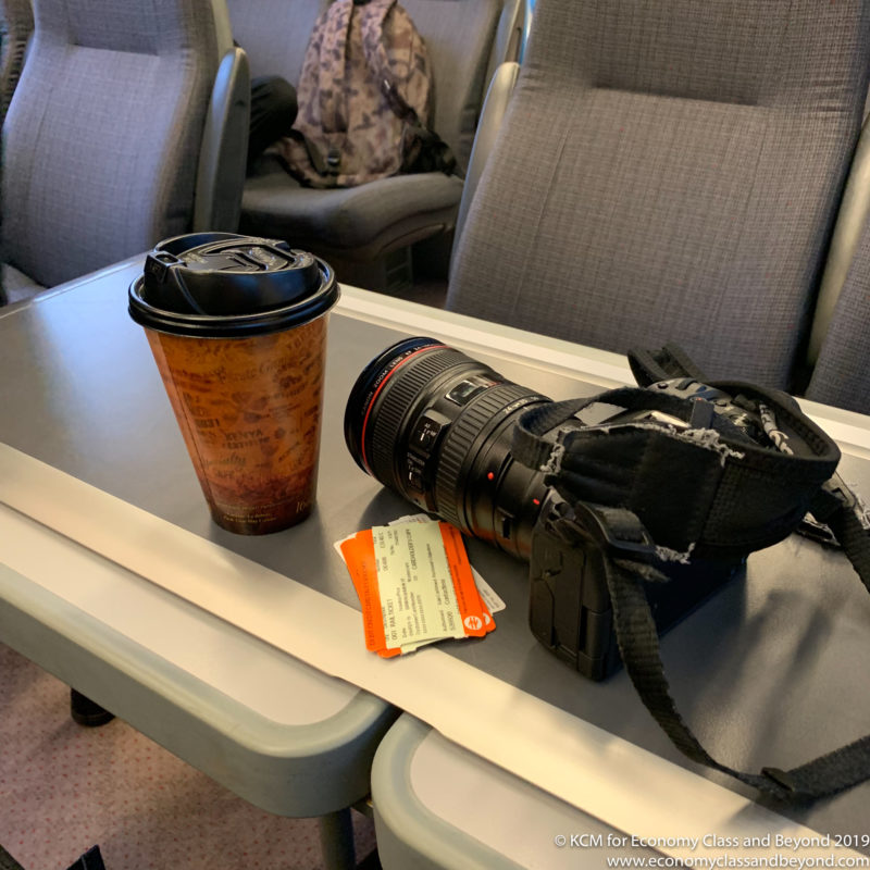 a camera and coffee cup on a table
