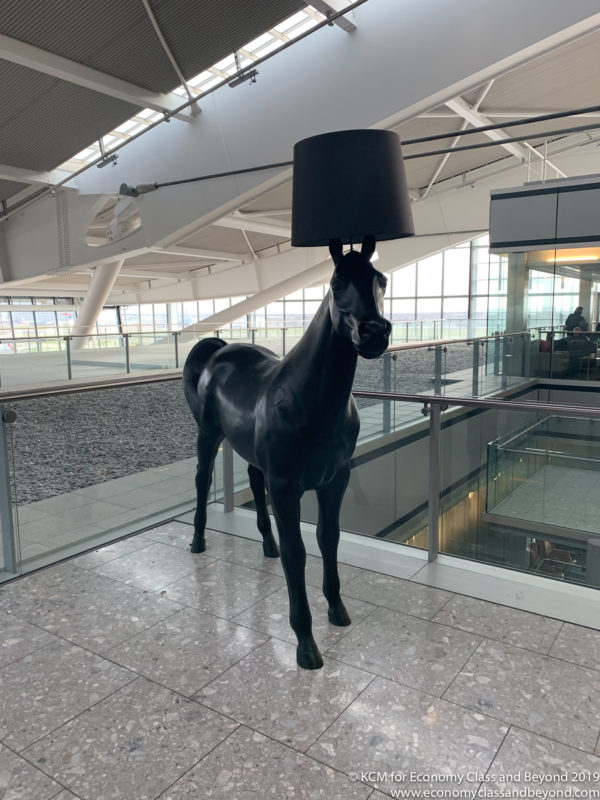 a statue of a horse with a lamp on its head