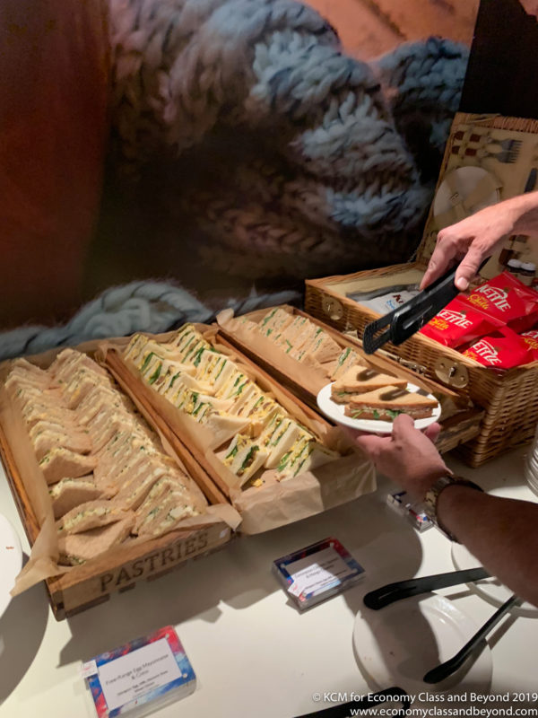 a person serving sandwiches in a buffet