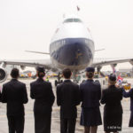 a group of people standing in front of an airplane