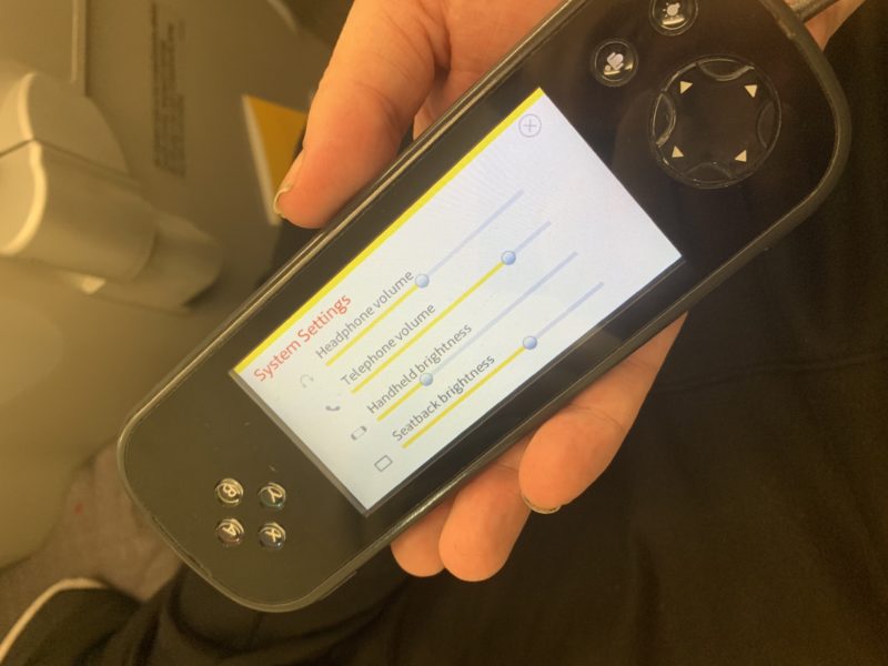 a hand holding a video game device