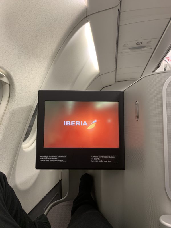 a screen on the wall of an airplane