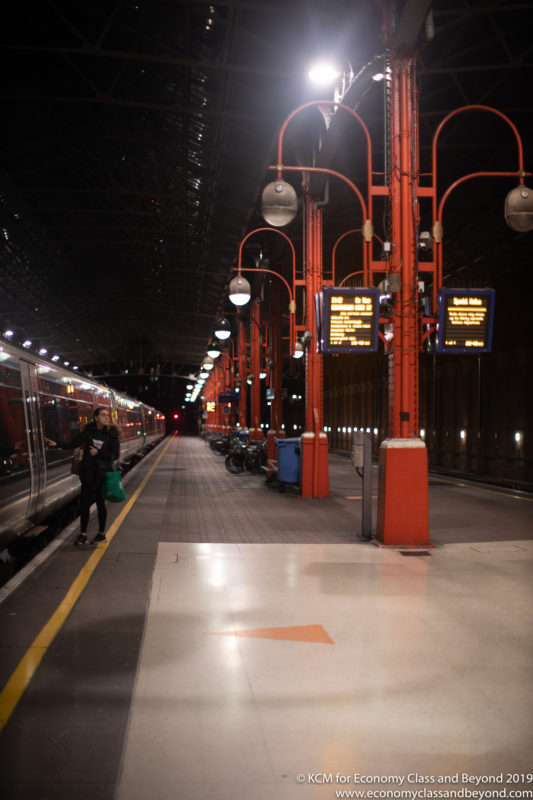 a woman standing at a train station