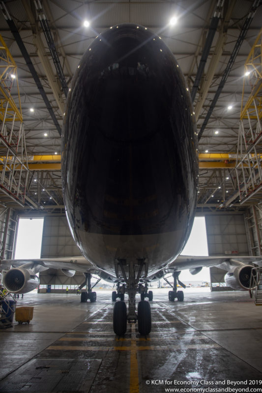 a large black airplane in a hangar