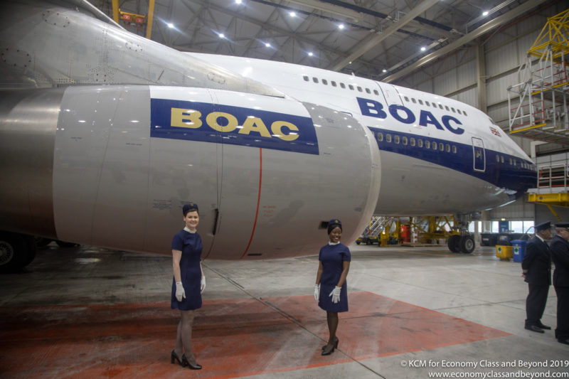 two women standing in front of an airplane