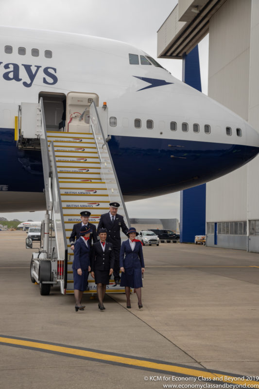 a group of people standing on stairs of a plane