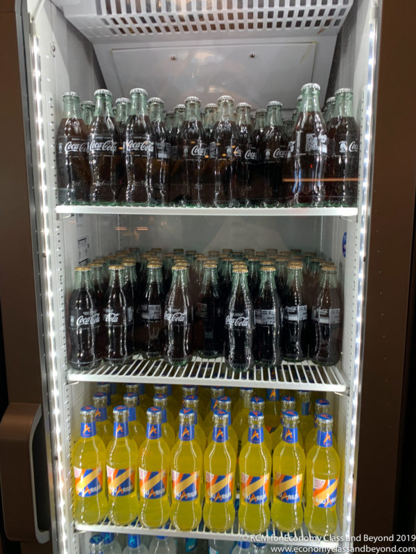 a shelf of soda bottles
