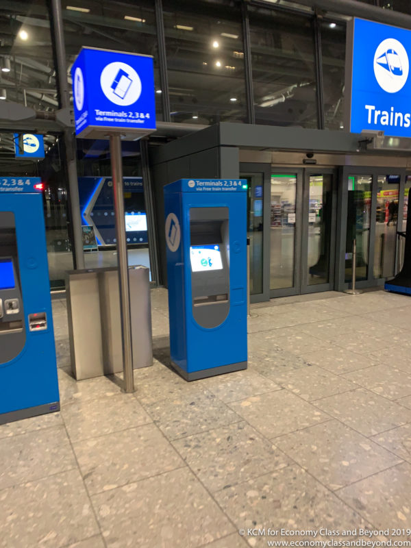 a blue machine in a train station