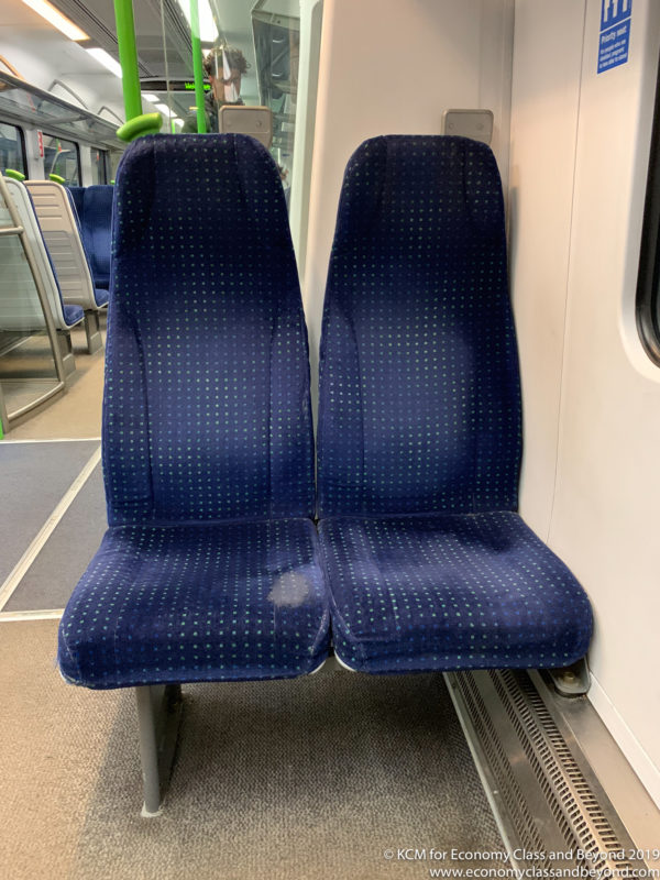 a blue and green seats on a train