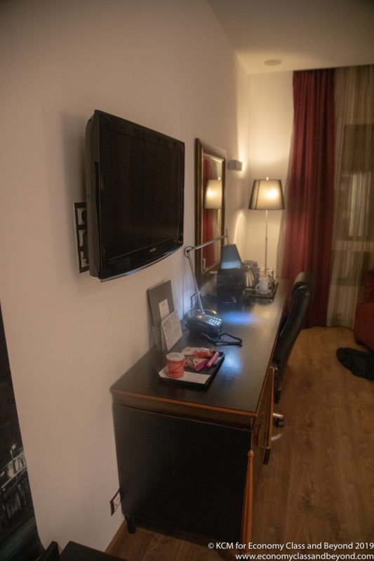 a desk with a tv on the wall