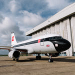 a plane parked in front of a building