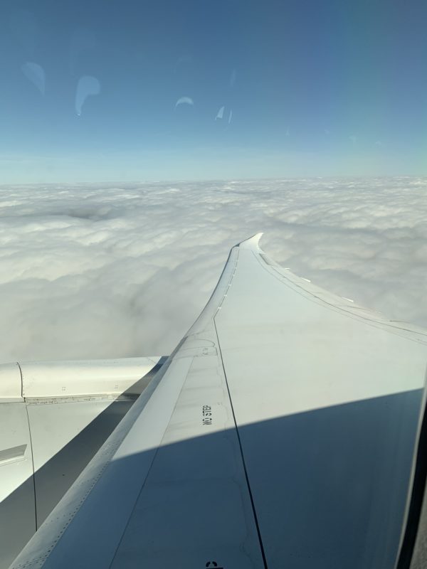 wing of an airplane above the clouds