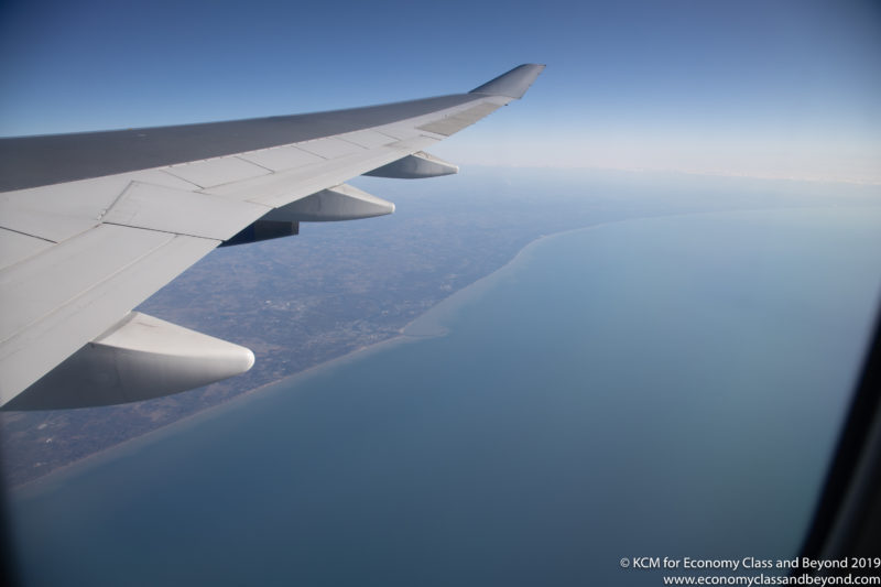 an airplane wing and land and water