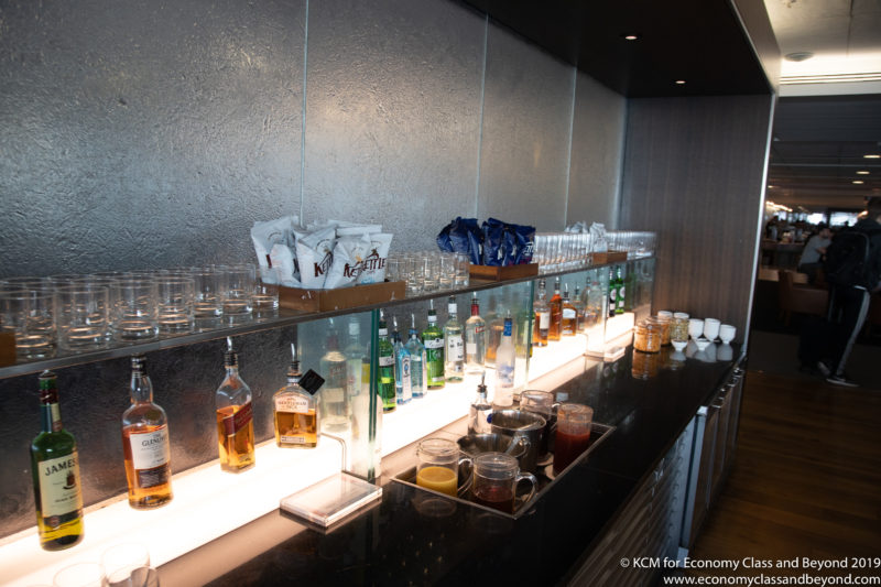 a bar with many glasses and bottles
