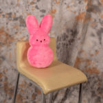 a pink stuffed bunny on a chair