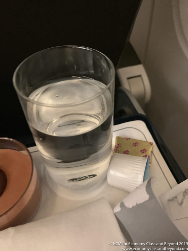 a glass of water on a tray