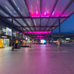 a covered area with pink lights