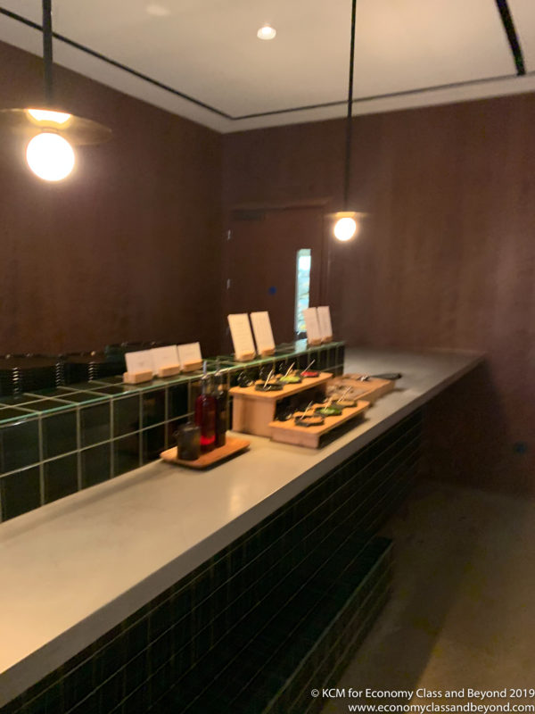 a counter with plates and bottles on it