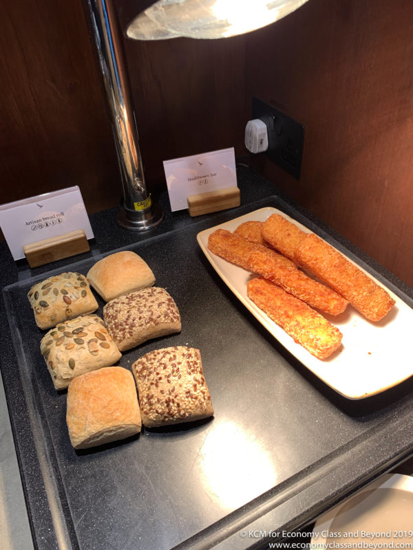 a plate of bread sticks and rolls on a counter