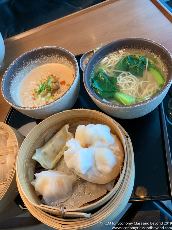 a group of bowls of soup and noodles