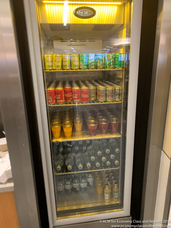 a refrigerator full of soda cans and bottles