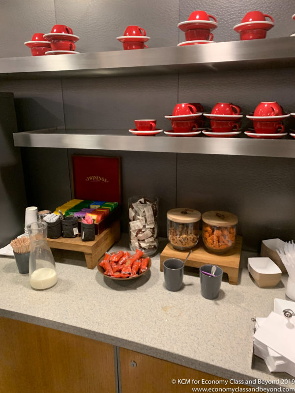 a counter with a shelf with red cups and candy