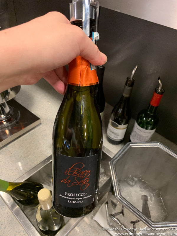 a hand holding a bottle of wine