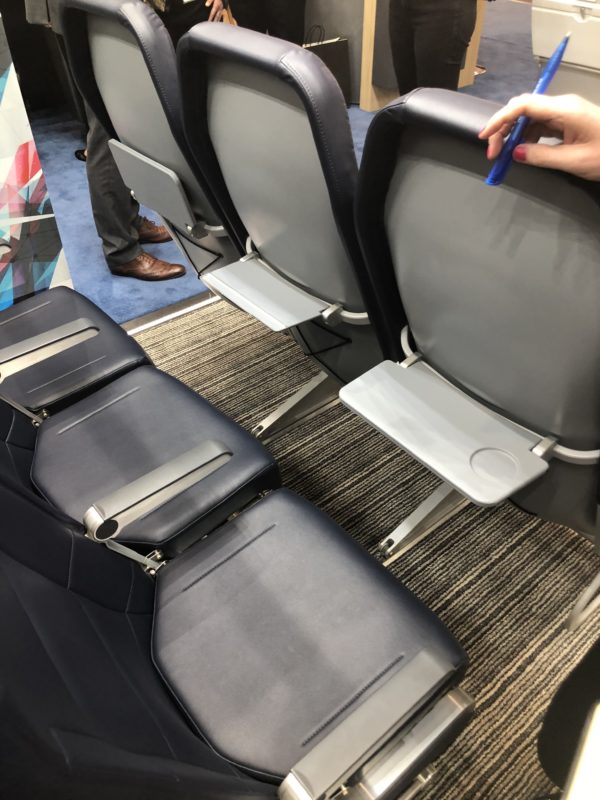 a person holding a blue marker in a row of seats