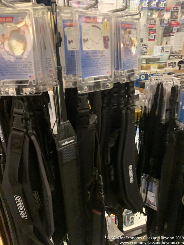 a group of black bags on a rack