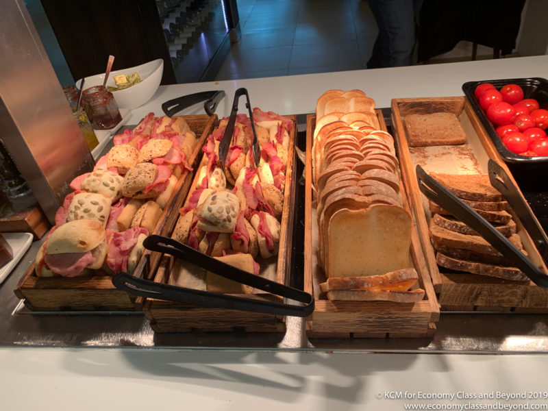 a trays of sandwiches and bread on a table