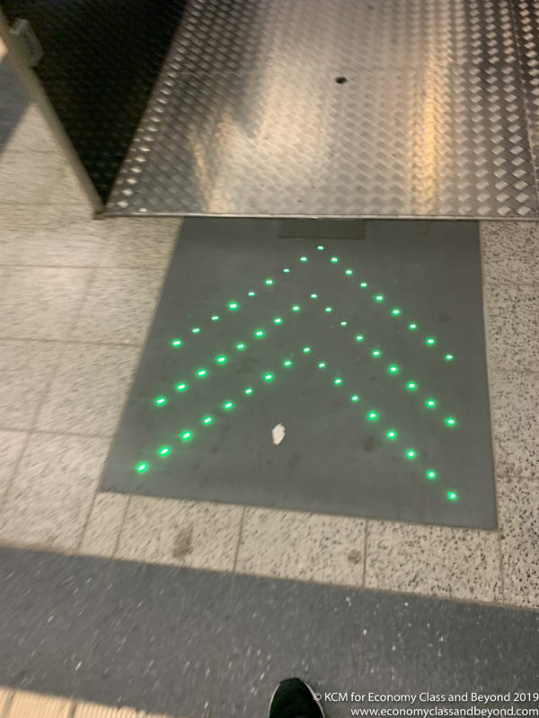 a green arrow on a floor
