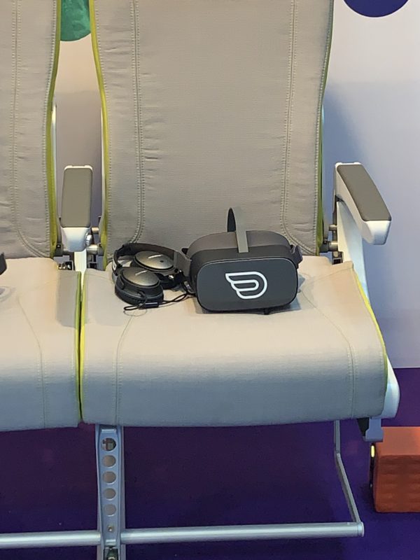 a pair of chairs with headphones and a vr headset